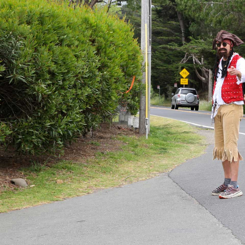 Miwok 100K Trail Race volunteer dressed as pirate and directing runners