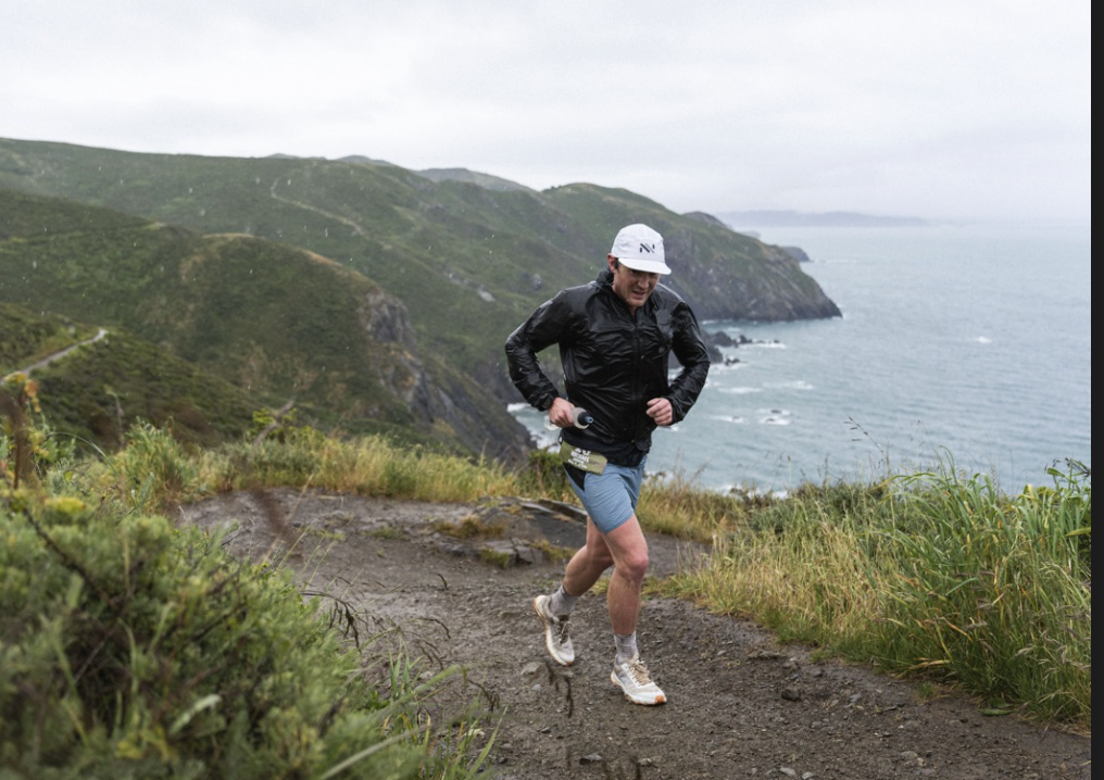 Lead male runner on the trail above Pirate's Cove