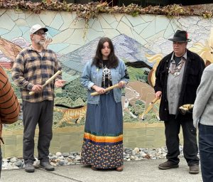Two older male members and one young female member of the Coast Miwok Tribe hosting a presentation at the Marin Humane Society.